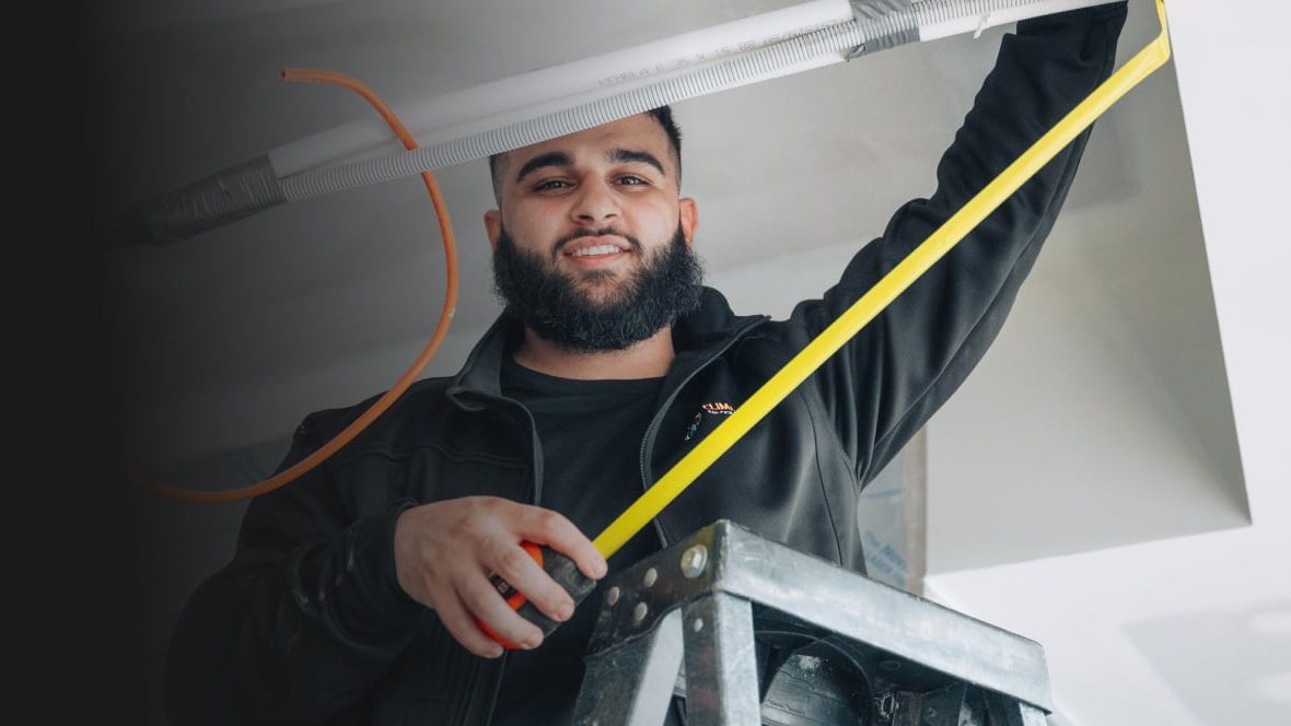 ClimaCool technician measuring a room before sizing an air conditioner