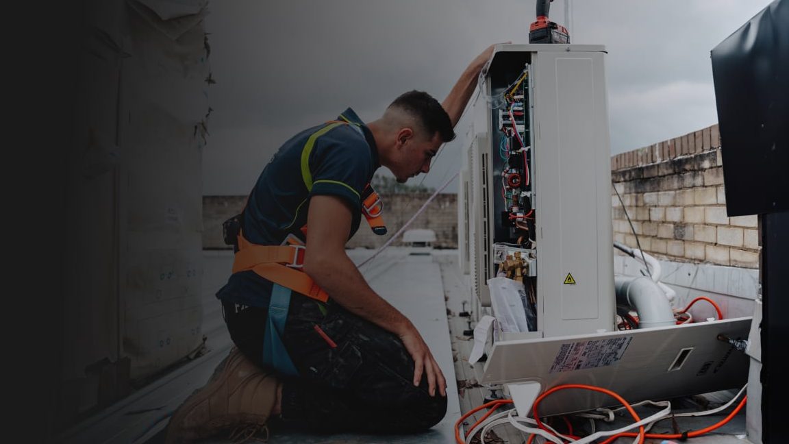 ClimaCool technician servicing an air conditioner outdoor unit