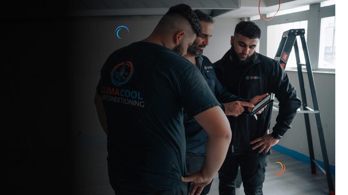 ClimaCool team reviewing air conditioning options on a tablet