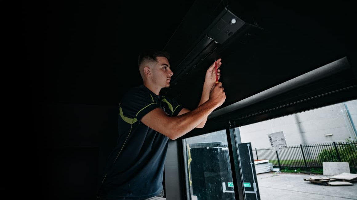 ClimaCool technician working on ducted air conditioning in the ceiling